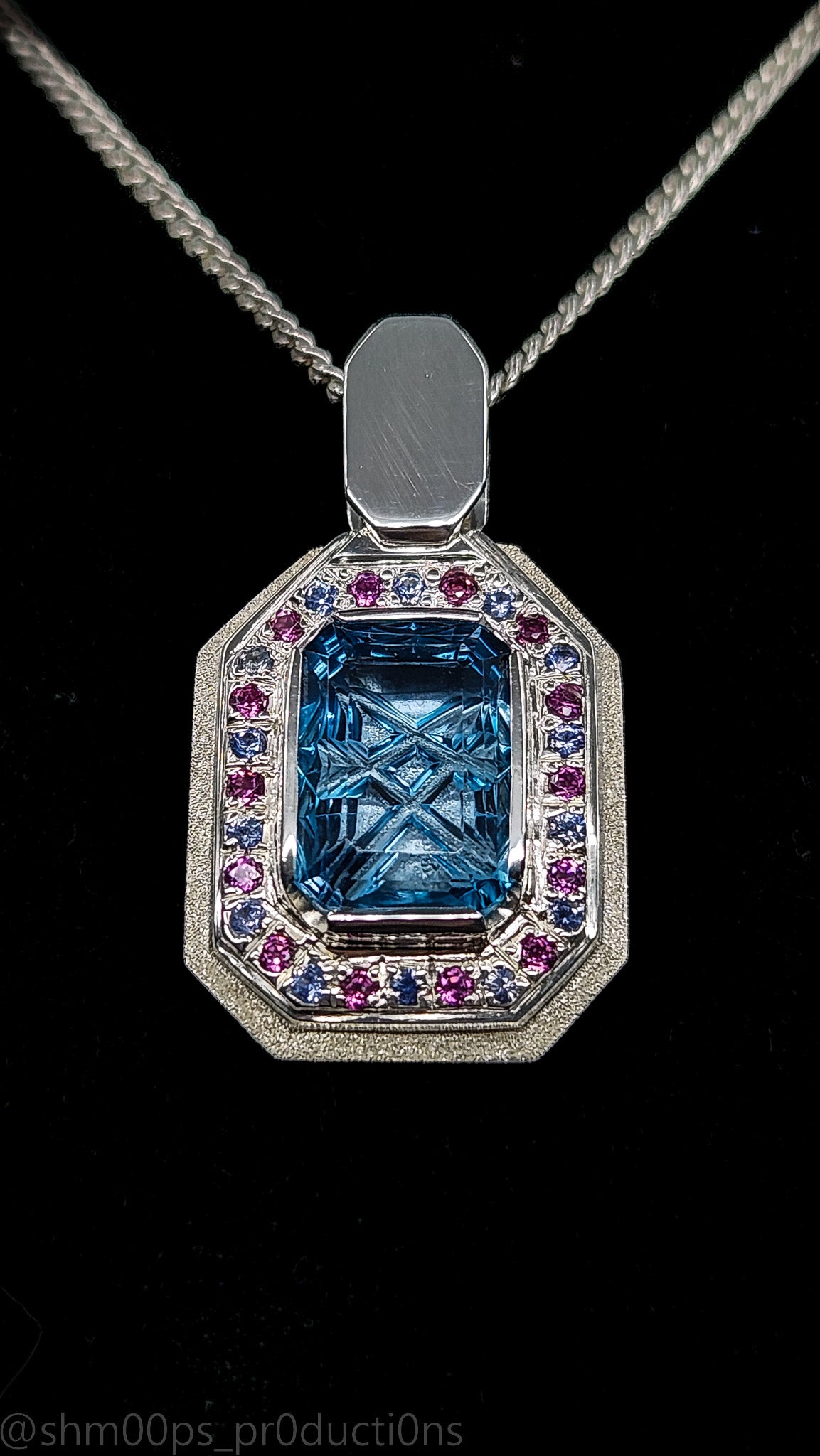 "Azure Enchantment: Blue Topaz Pendant with Sapphire and Garnet"